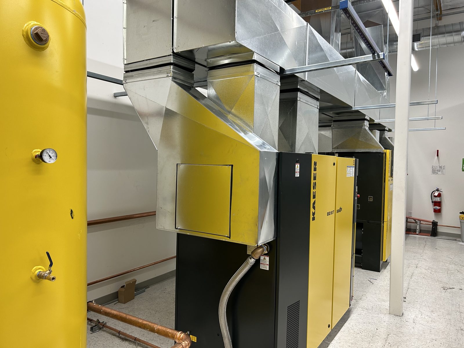 Ducting that carries heat away from an equipment room housing large air compressors